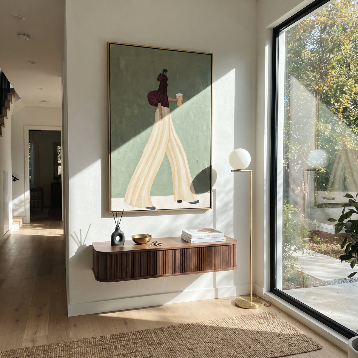 Burgundy Sleeve Ivory Steps – woman in a sculptural burgundy blouse and cream palazzo trousers walking with a takeaway cup, displayed in a styled contemporary interior