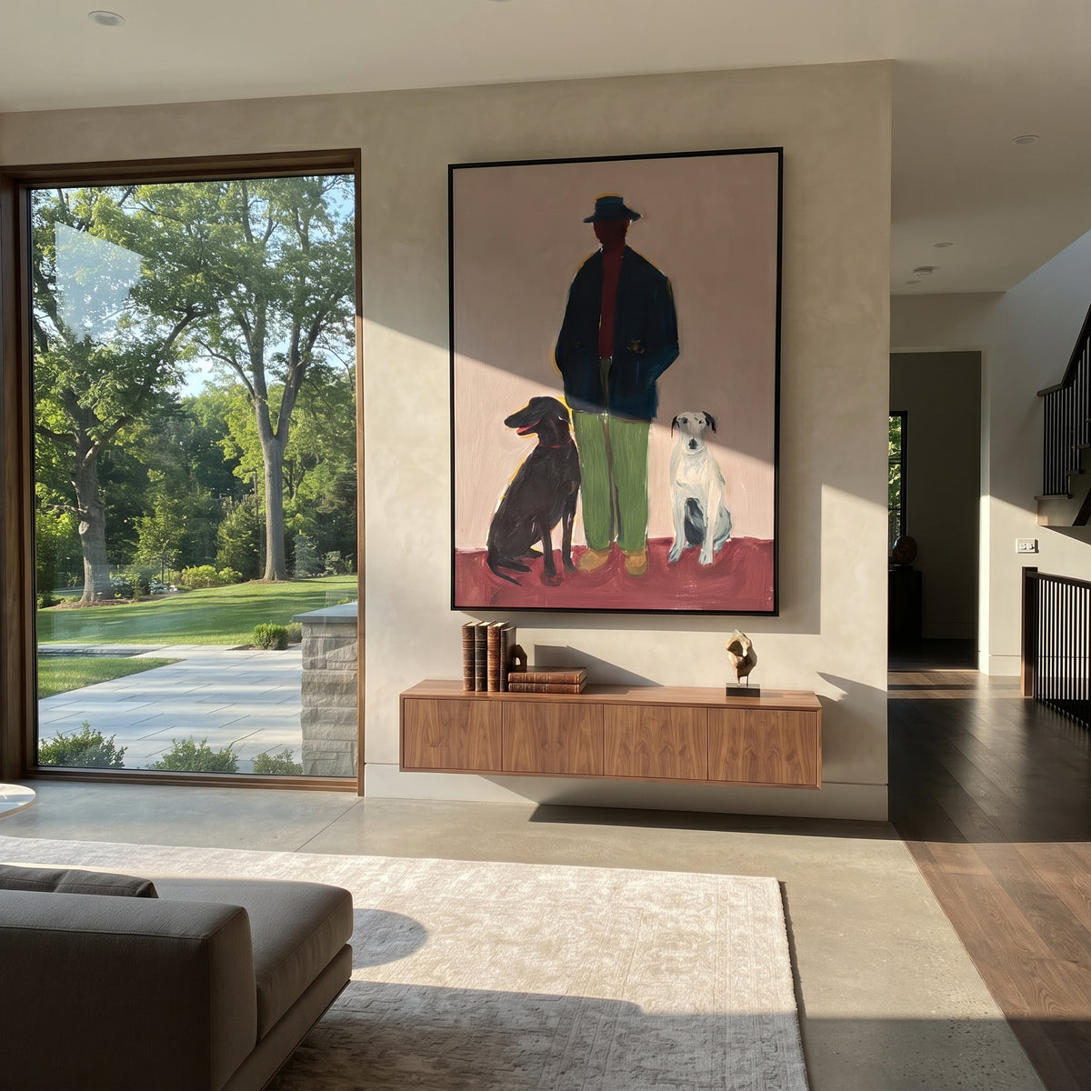Three Friends Mauve Morning man with black and white dogs painting displayed in a styled interior