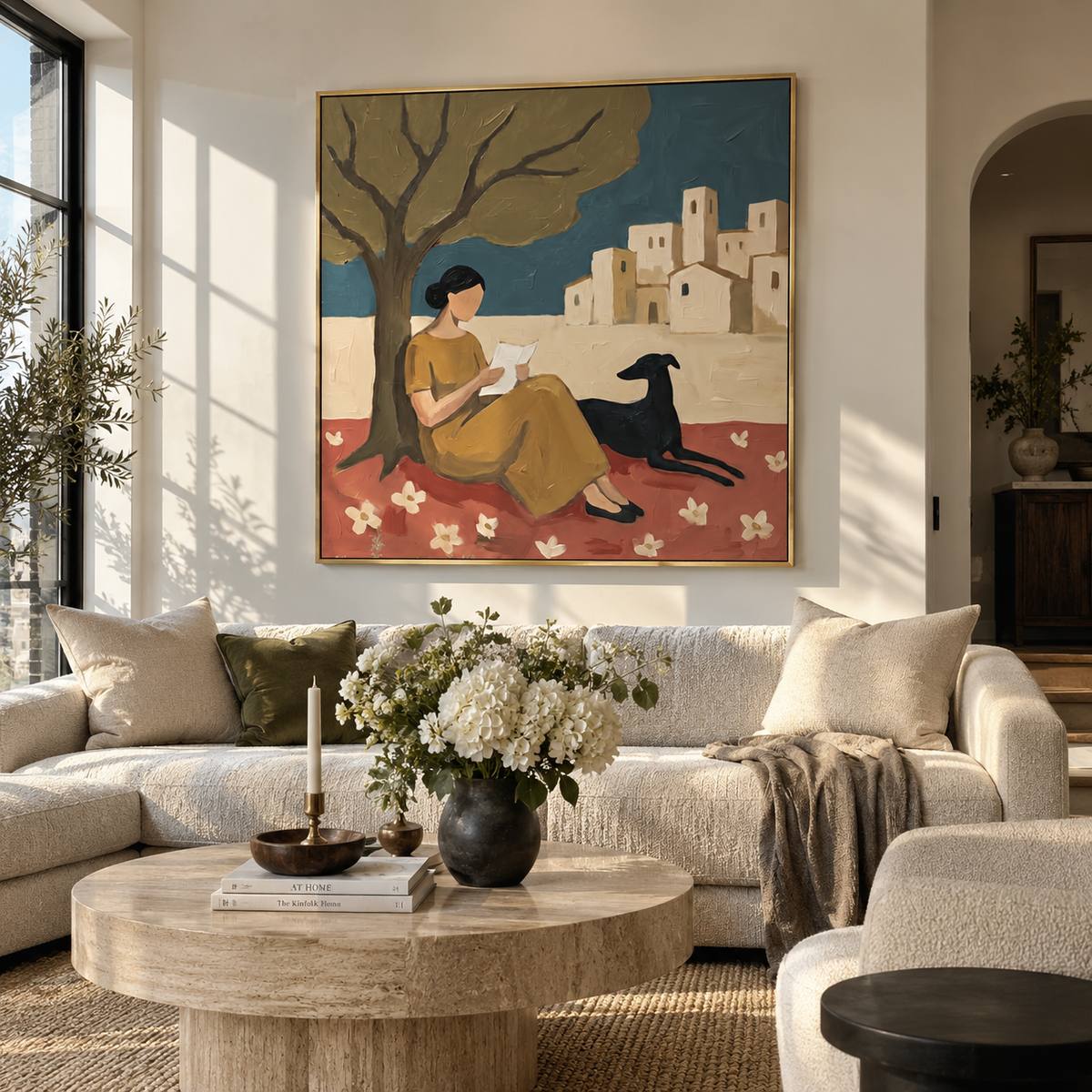 Reading Beneath Bare Branches woman reading with dog painting displayed in a styled interior