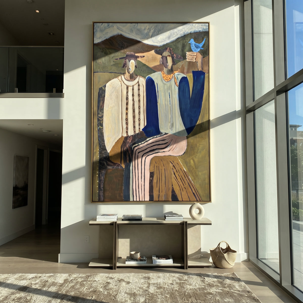 Blue Bird Joins the Gathering - two seated mountain figures painting, modern figurative vertical textured wall art - displayed along a sunlit hallway