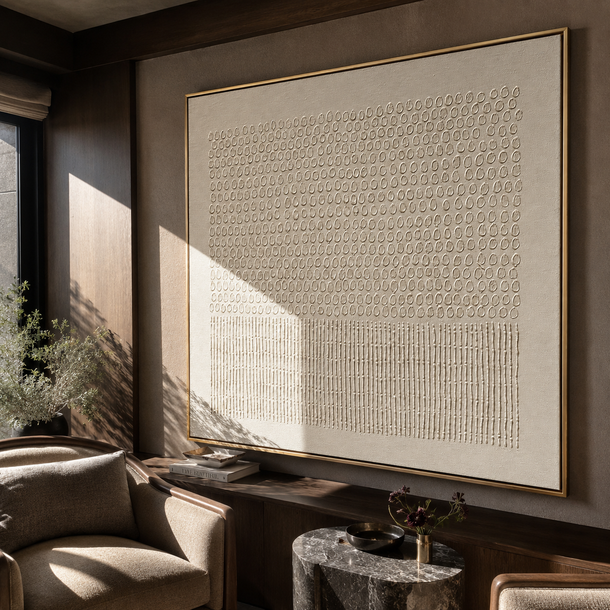 Pebbled plaster texture artwork displayed in a warm-toned living room seating area